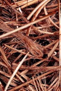 Close-up view of intertwined copper wires ready for recycling, emphasizing industrial reuse.